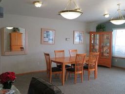 a dining room with a wooden table and chairs