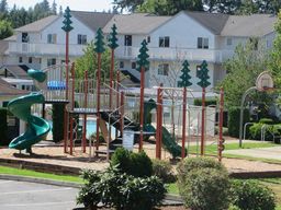 an image of a playground with a building in the background