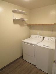 a white washer and dryer in a room with a wood floor
