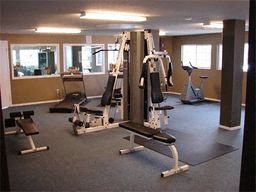 a gym with weights and other exercise equipment in a room