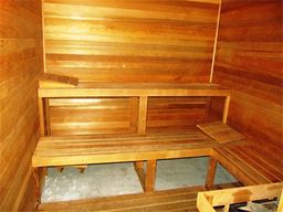 an empty sauna with wooden walls and a glass floor