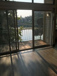 a living room with glass doors and a view of a lake