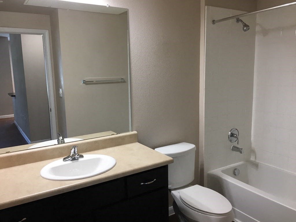 a bathroom with a sink toilet and a shower