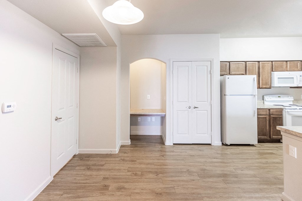 a renovated kitchen with white appliances and a white refrigerator