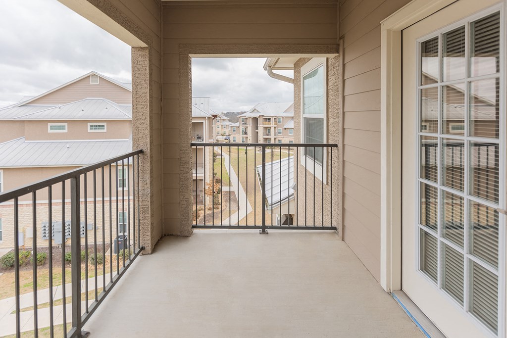 the view from the balcony of a home with a balcony door open