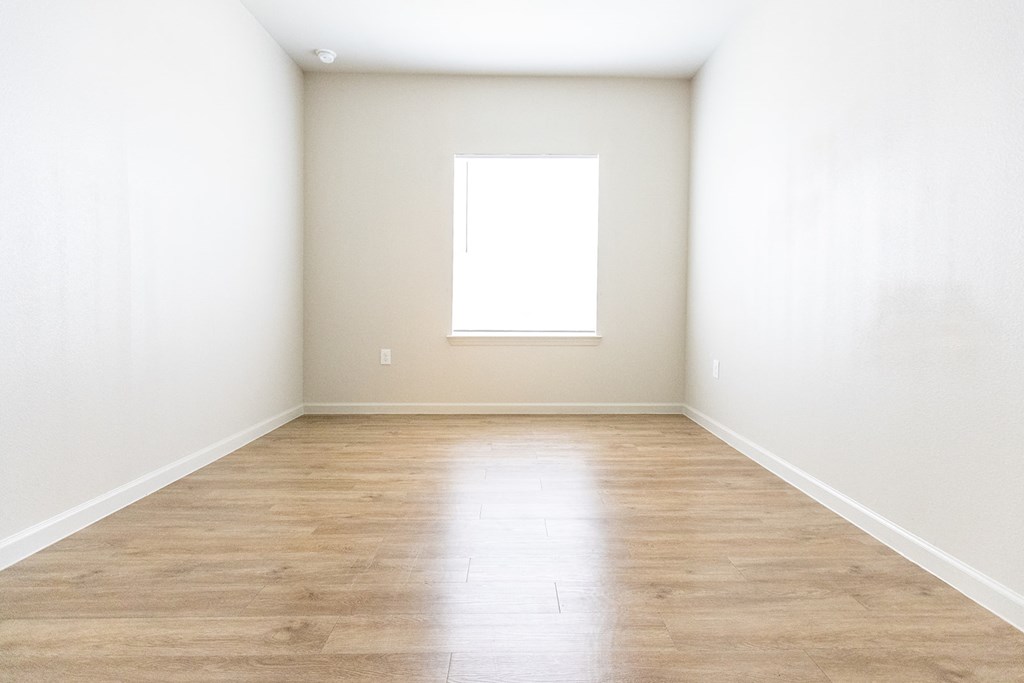 an empty room with white walls and a window