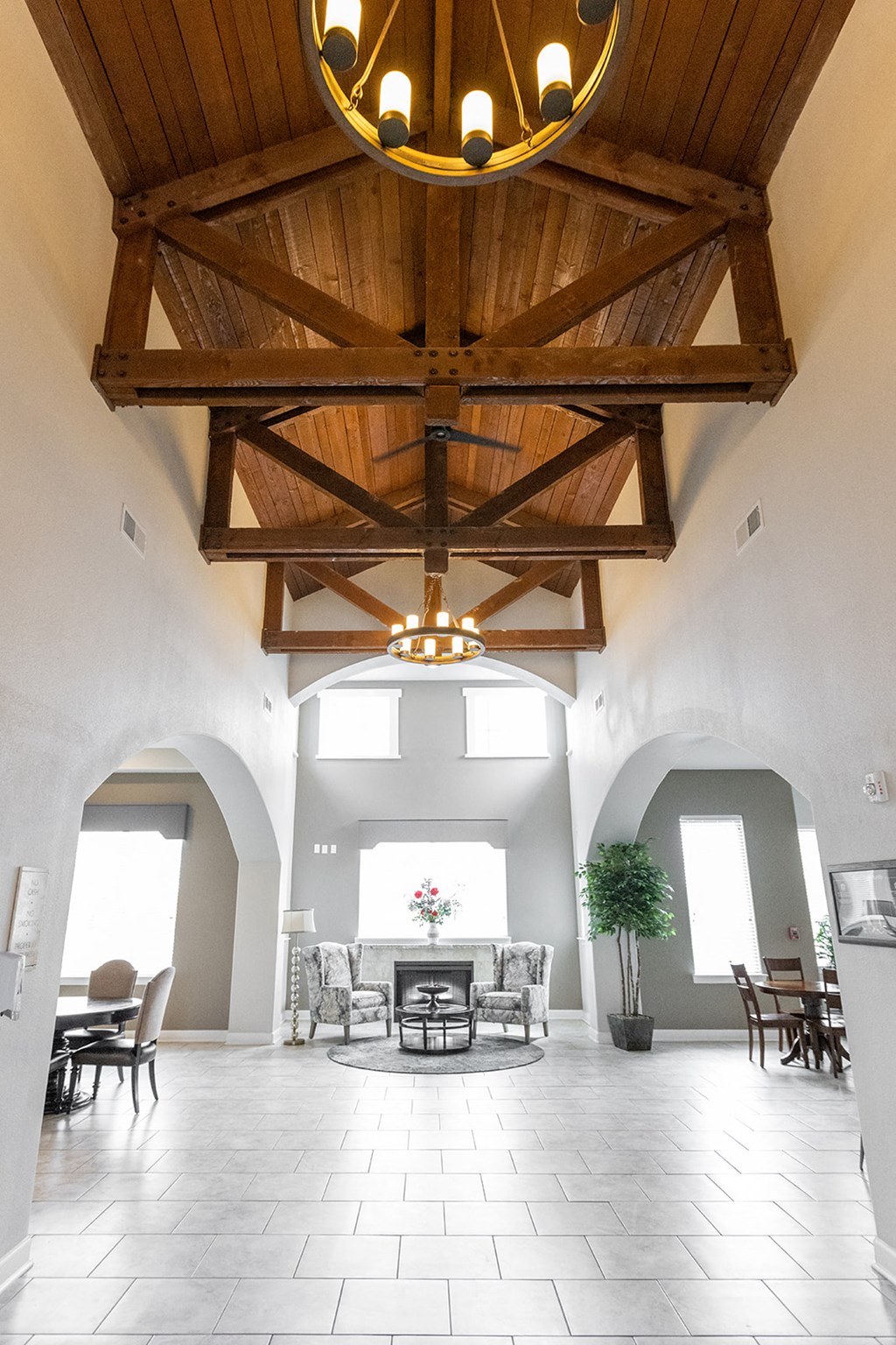 a large room with a vaulted ceiling and a table and chairs