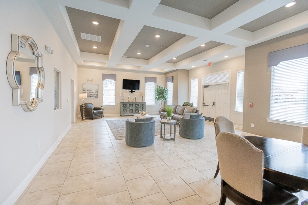 a large living room with a table and chairs