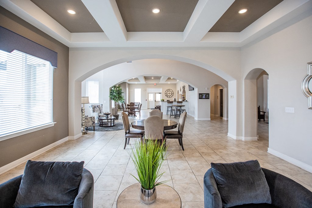 a living room and dining room with a table and chairs