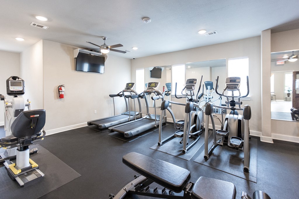 the gym at the district at highland village apartments