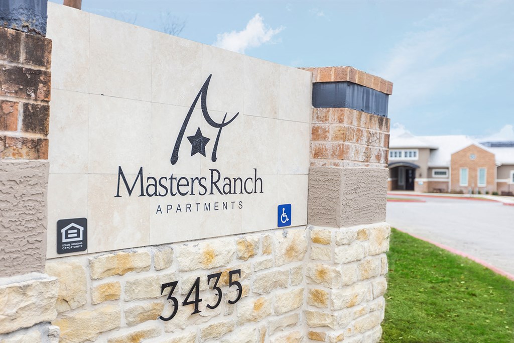 a stone building with a sign for master ranch apartments