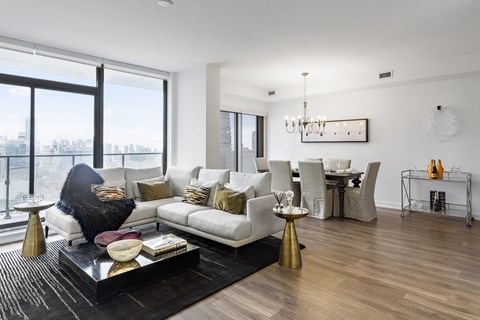 A modern living room with a white sofa and a black coffee table.
