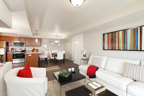 a living room and dining room with white furniture