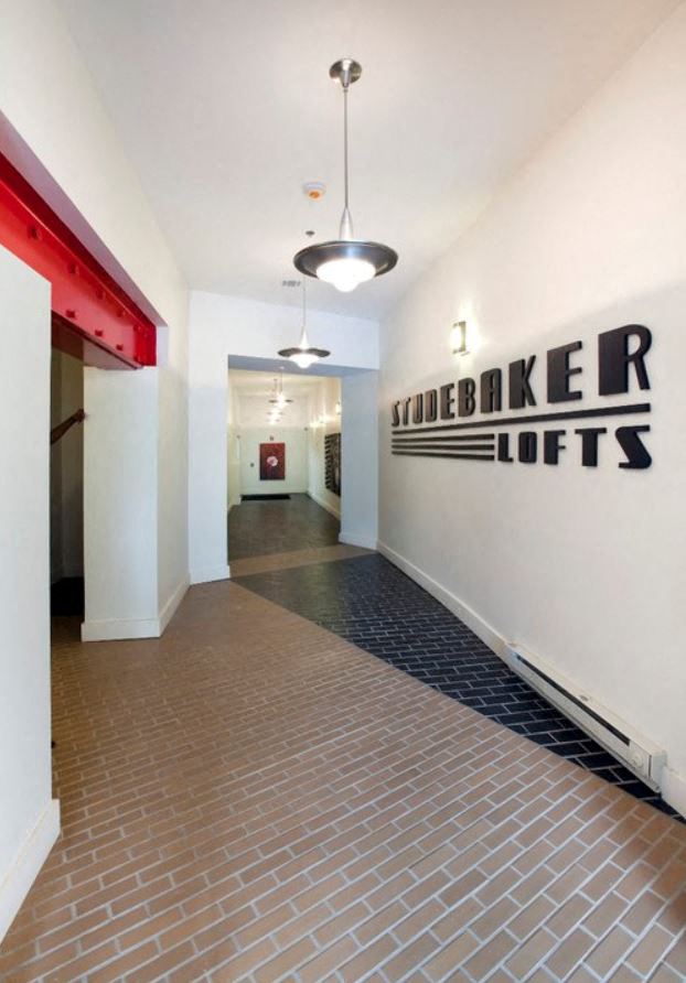 Entrance with logo on walls and modern beige and black tile designed floors