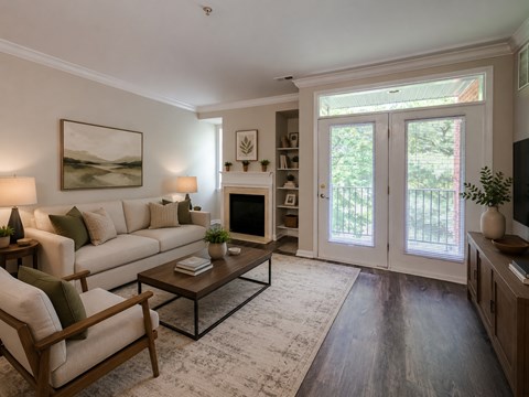A living room with a white couch, a coffee table, and a painting on the wall.