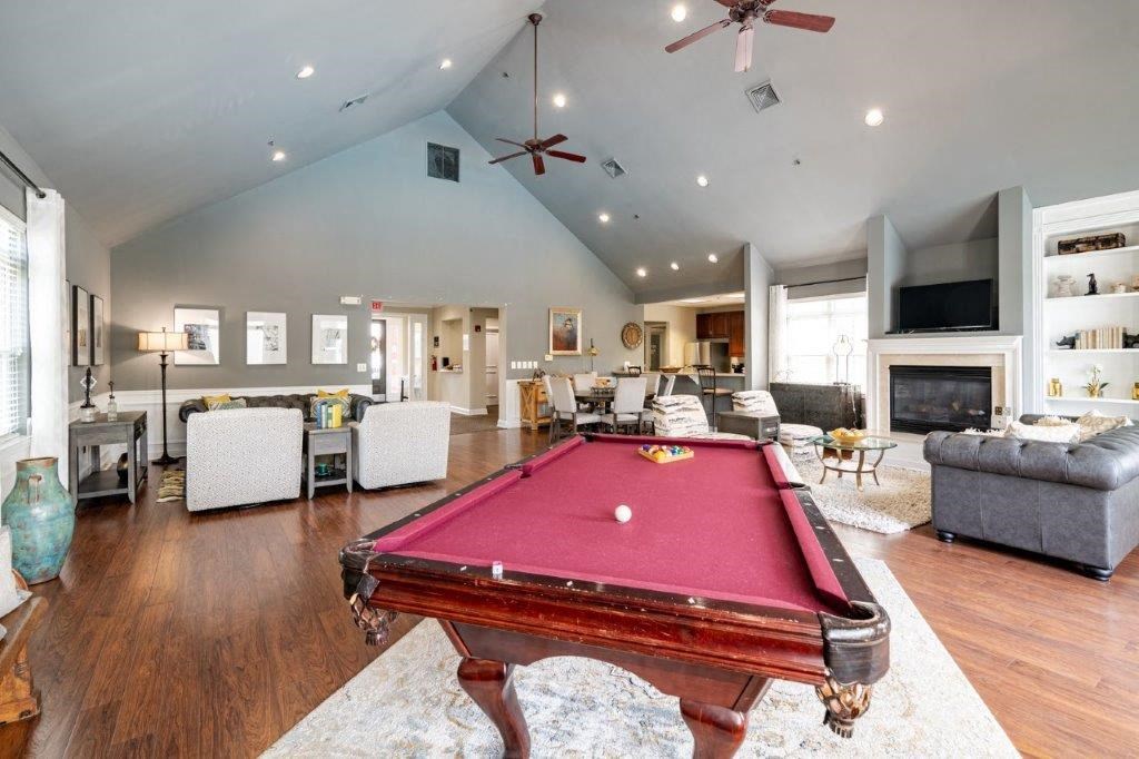 a pool table in the center of a living room