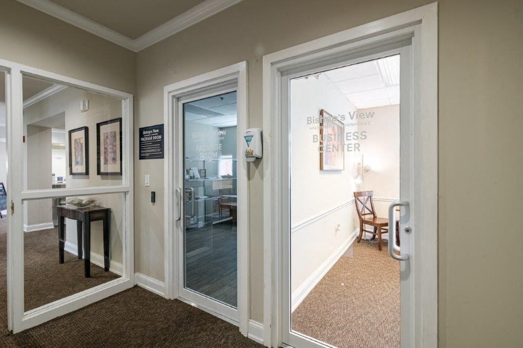 a hallway with a door to a living room and a dining room