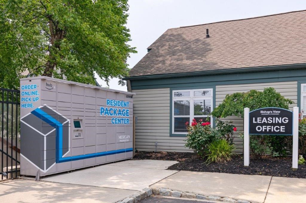 a building with a leasing office and a sign in front of it