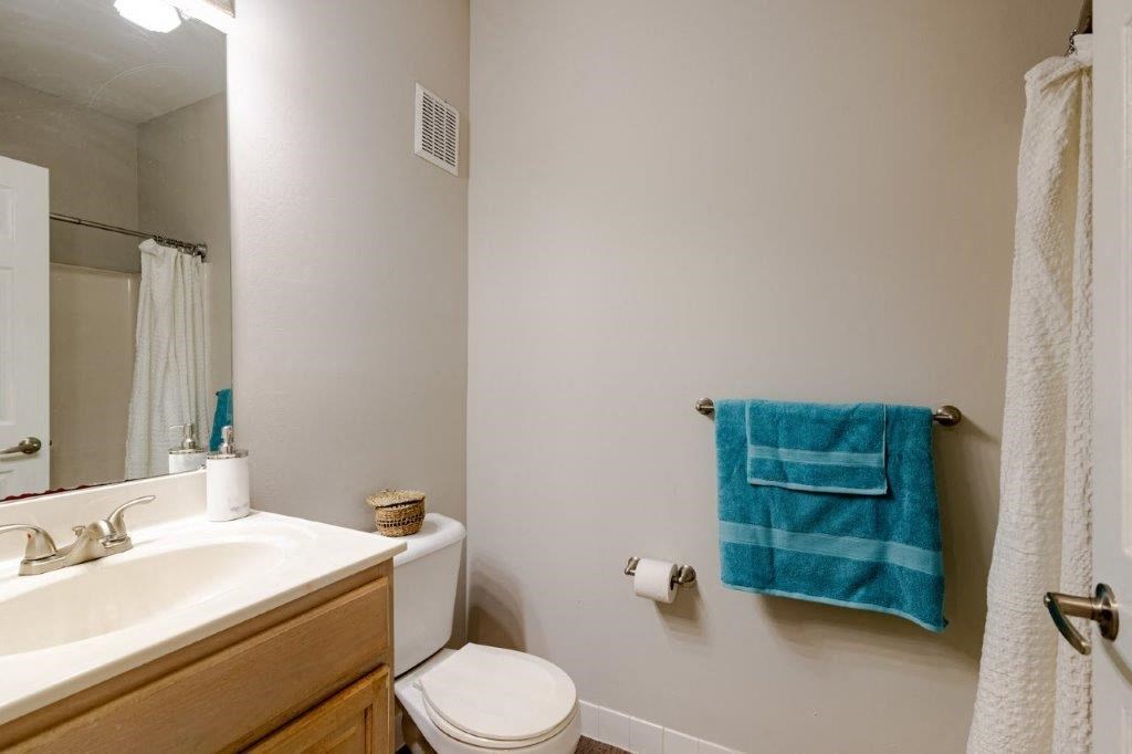 a bathroom with a sink toilet and a mirror