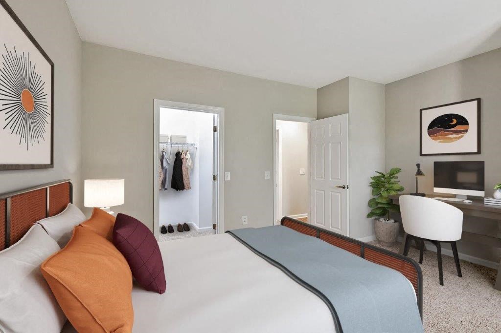 a bedroom with a bed and a desk and a closet