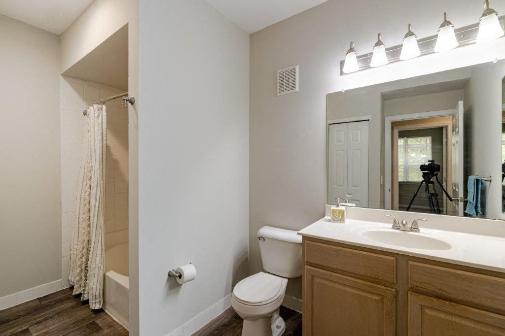 a bathroom with a toilet sink and a mirror