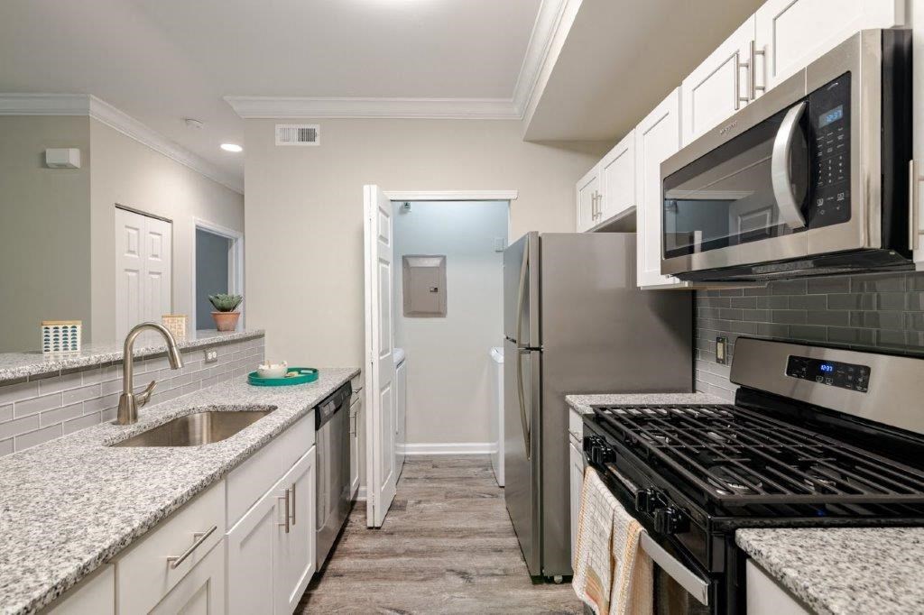 a kitchen with stainless steel appliances and granite counter tops