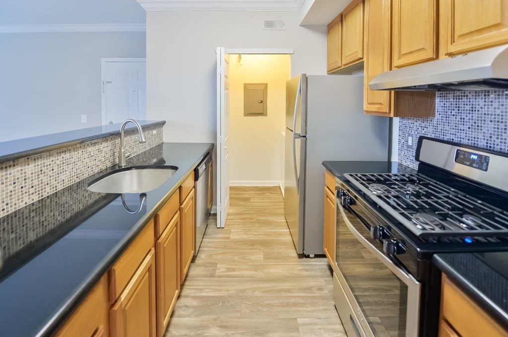 a kitchen with stainless steel appliances and wooden cabinets