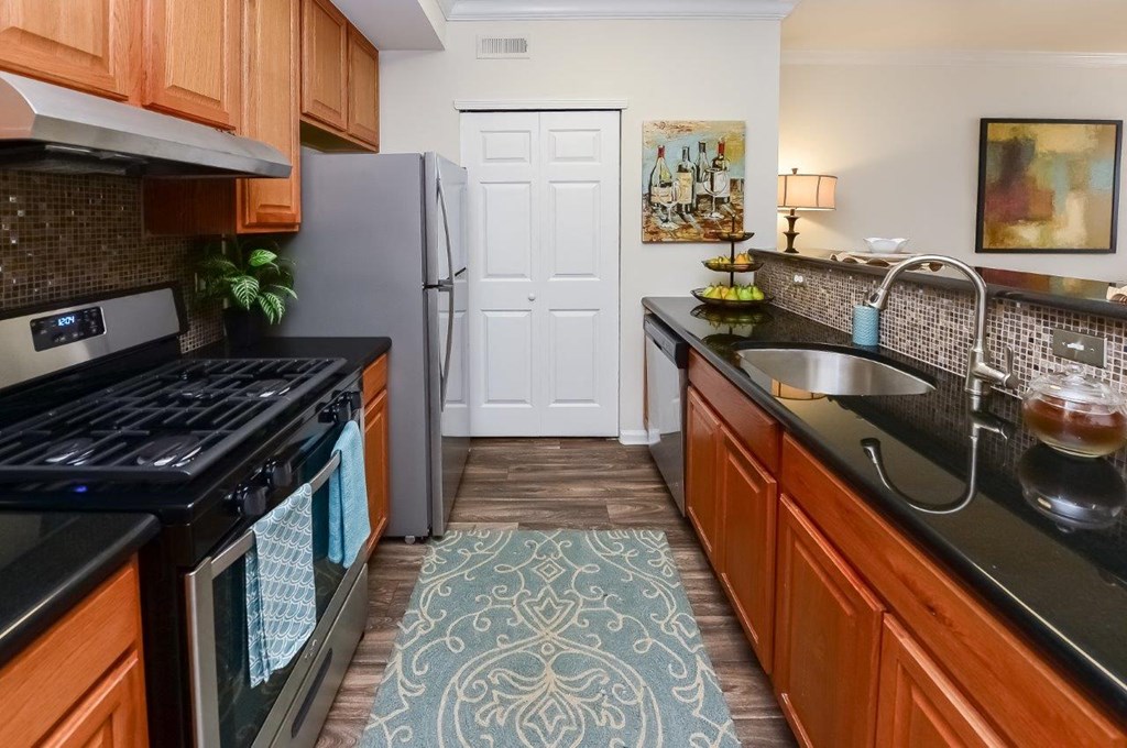 a kitchen with stainless steel appliances and wooden cabinets