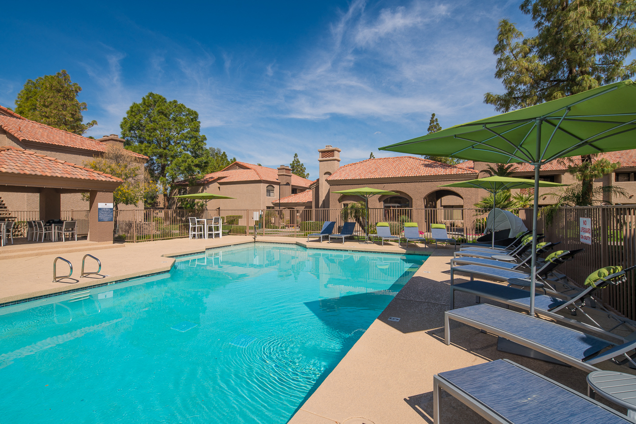 Outdoor pool area with lounge chairs