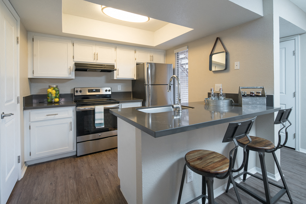 Kitchen with stainless steel appliances and bar seating
