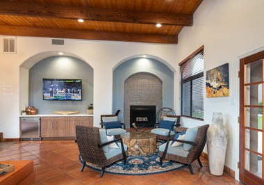 Clubroom with seating area, fireplace, and TV