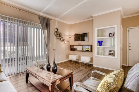 A living room with a wooden coffee table and a white couch.