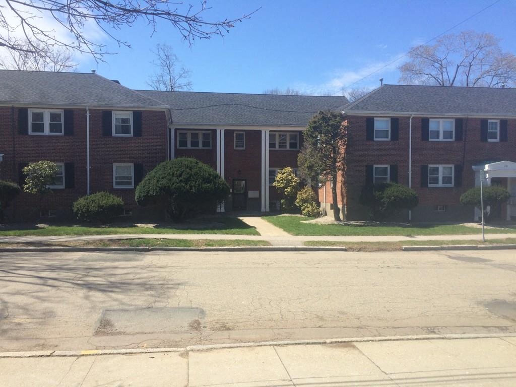 an apartment building with a street in front of it