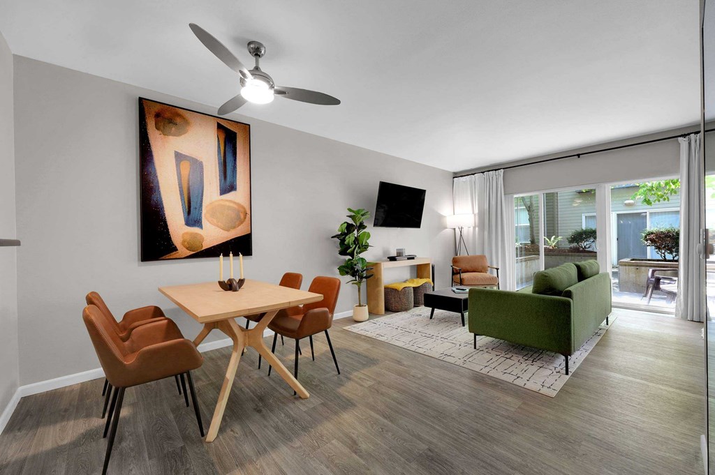 A modern dining room with a wooden table and chairs.