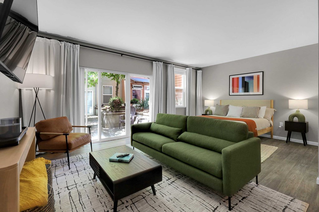 A living room with a green couch and a coffee table.