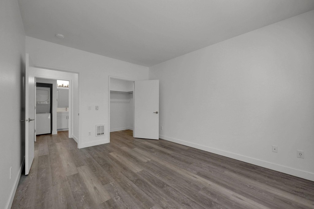 A room with a white door and a white wall.