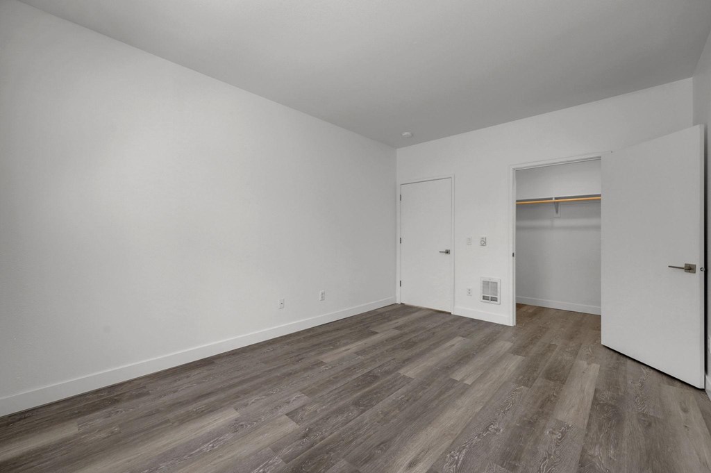 A room with a white door and a white wall.