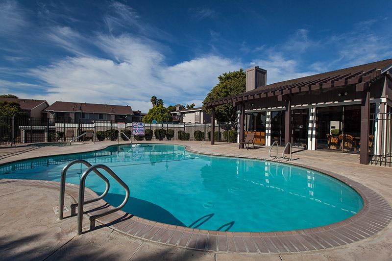 a large swimming pool in front of a building