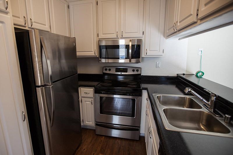 a kitchen with stainless steel appliances and white cabinets
