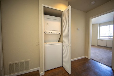 an empty room with a washer and dryer in a closet