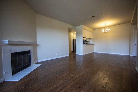 a empty living room with a fireplace