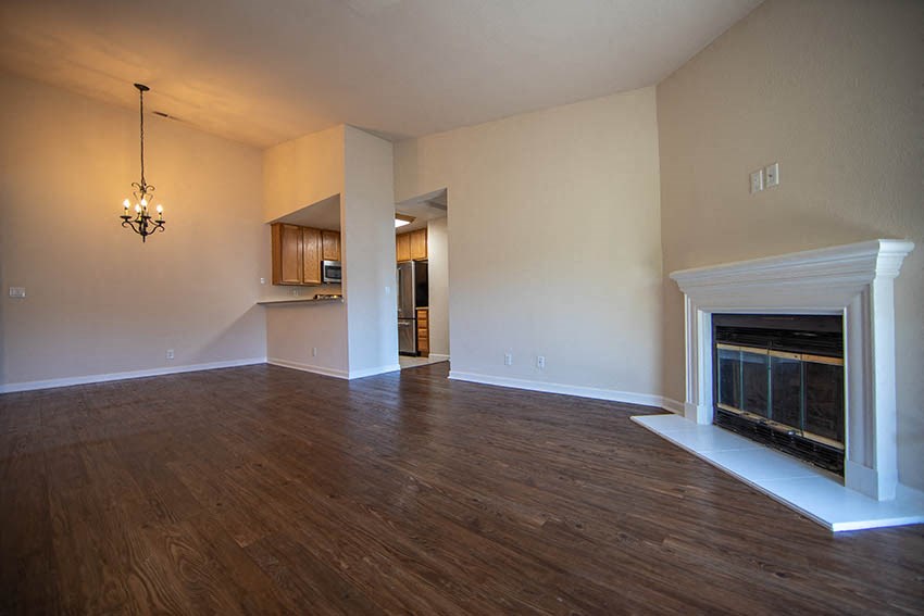 a empty living room with a fireplace