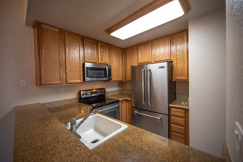 a kitchen with a sink and a refrigerator
