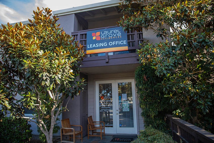 the front of a building with a leasing office sign