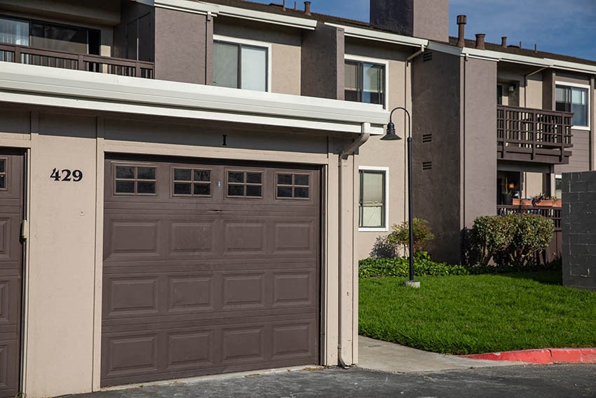 a garage door on the side of an apartment building