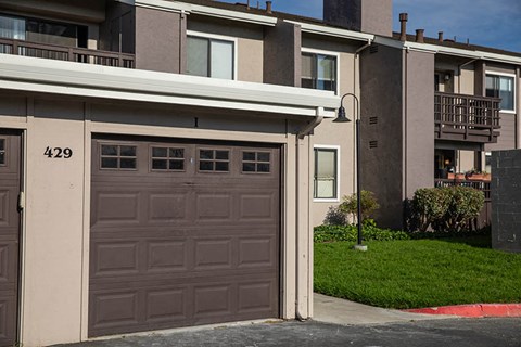 a garage door on the side of an apartment building