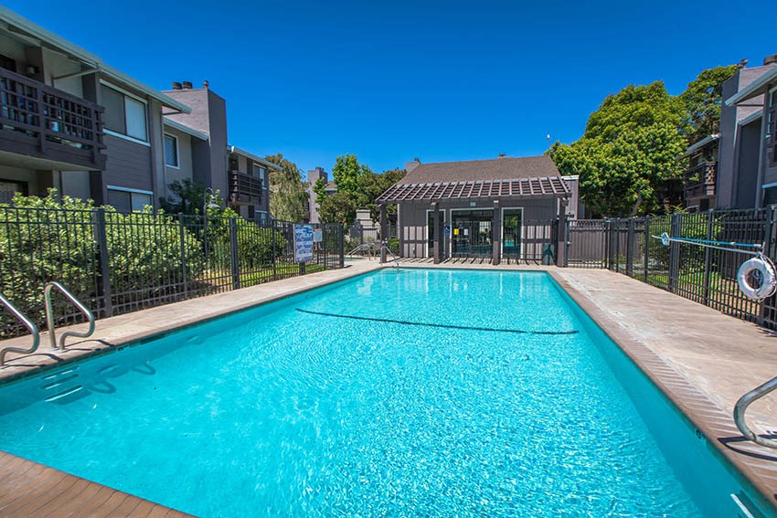 a swimming pool with a house in the background