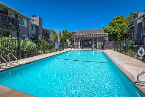 a swimming pool with a house in the background