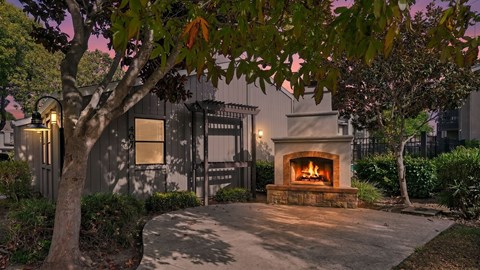 A house with a lit fireplace in the front yard.