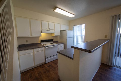 a kitchen with white appliances and counter tops
